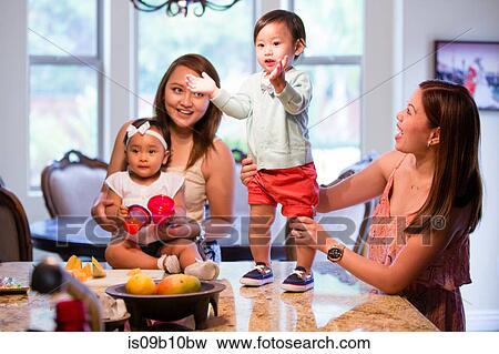 Baby boy standing and clapping hands on dining room table View Large Photo Image Stock Photo - Baby boy standing and clapping hands on dining room table. Fotosearch