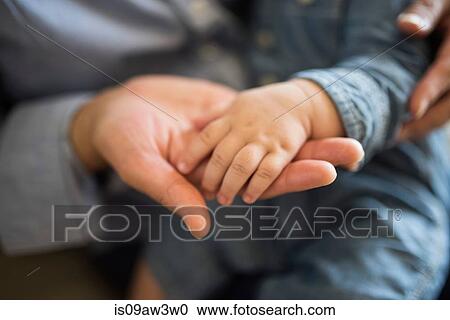 Baby's hand on adult's hand View Large Photo Image Stock Image - Baby's hand on adult's hand. Fotosearch