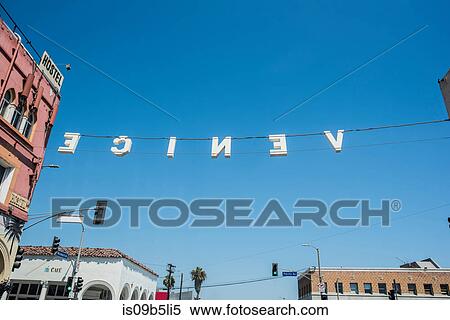 Stock Photography - Backwards sign against blue sky, Venice beach, California, USA. Fotosearch