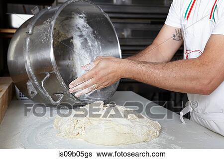 Baker in bakery, making bread View Large Photo Image Stock Photograph - Baker in bakery, making bread. Fotosearch