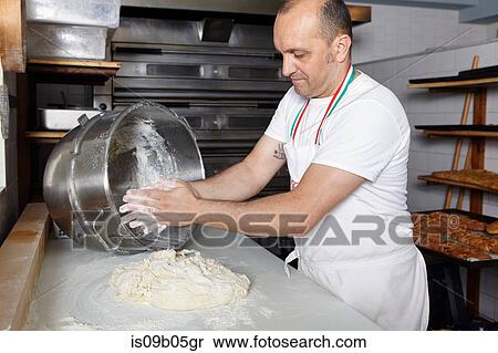 Baker in bakery, making bread View Large Photo Image Stock Photography - Baker in bakery, making bread. Fotosearch