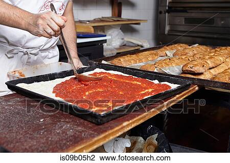 Baker working in bakery, mid section View Large Photo Image Stock Image - Baker working in bakery, mid section. Fotosearch