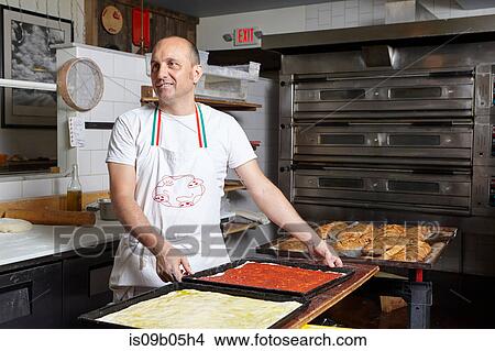Baker working in bakery View Large Photo Image Picture - Baker working in bakery. Fotosearch