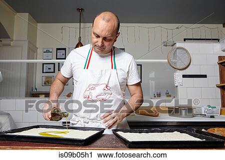 Baker working in bakery View Large Photo Image Stock Image - Baker working in bakery. Fotosearch
