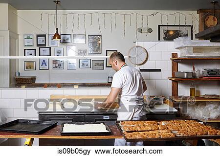 Baker working in bakery View Large Photo Image Stock Photo - Baker working in bakery. Fotosearch