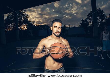 Bare chested man on basketball court holding basketball looking at camera View Large Photo Image Stock Photo - Bare chested man on basketball court holding basketball looking at camera. Fotosearch