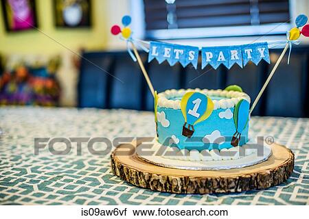 Birthday cake for first birthday party on kitchen table View Large Photo Image Stock Image - Birthday cake for first birthday party on kitchen table. Fotosearch