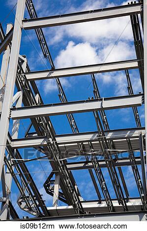 Blue sky through cross beams and girders on construction frame View Large Photo Image Picture - Blue sky through cross beams and girders on construction frame. Fotosearch