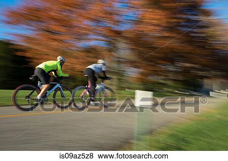 Blurred motion of cyclists cycling View Large Photo Image Stock Photo - Blurred motion of cyclists cycling. Fotosearch