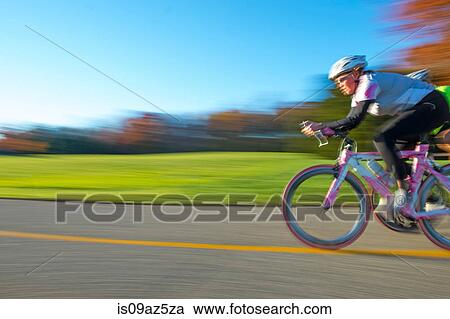 Blurred motion side view of cyclist cycling View Large Photo Image Stock Image - Blurred motion side view of cyclist cycling. Fotosearch