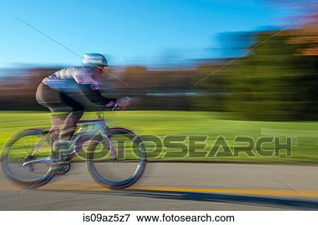 Blurred motion side view of cyclist cycling View Large Photo Image Stock Photo - Blurred motion side view of cyclist cycling. Fotosearch