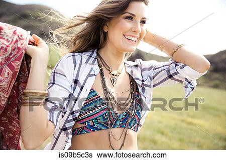 Boho style young woman in bikini top carrying picnic blanket View Large Photo Image Stock Photograph - Boho style young woman in bikini top carrying picnic blanket. Fotosearch