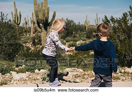Boy and girl holding hands, Wadell, Arizona, USA View Large Photo Image Picture - Boy and girl holding hands, Wadell, Arizona, USA. Fotosearch