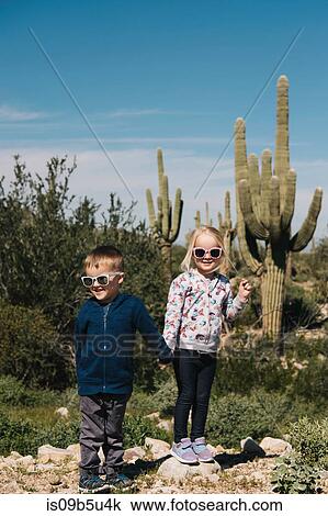 Boy and girl holding hands, Wadell, Arizona, USA View Large Photo Image Stock Image - Boy and girl holding hands, Wadell, Arizona, USA. Fotosearch