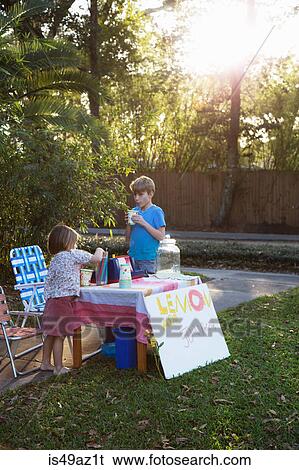 Boy and sister drinking lemonade from lemonade stand in garden View Large Photo Image Stock Photograph - Boy and sister drinking lemonade from lemonade stand in garden. Fotosearch