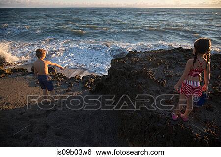Boy and sister pointing at ocean waves from beach, Blowing Rocks Preserve, Jupiter Island, Florida, USA View Large Photo Image Stock Photograph - Boy and sister pointing at ocean waves from beach, Blowing Rocks Preserve, Jupiter Island, Florida, USA. Fotosearch
