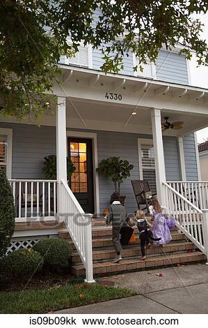 Boy and sisters trick or treating moving up porch stairway View Large Photo Image Stock Image - Boy and sisters trick or treating moving up porch stairway. Fotosearch
