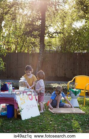 Boy and two young sisters preparing lemonade stand in garden View Large Photo Image Stock Photography - Boy and two young sisters preparing lemonade stand in garden. Fotosearch