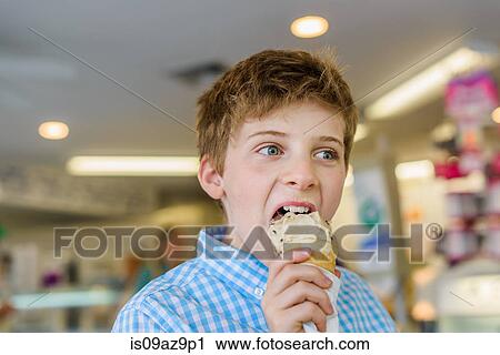 Boy eating ice cream cone View Large Photo Image Stock Image - Boy eating ice cream cone. Fotosearch