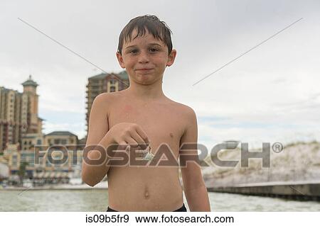 Boy holding blue crab, Gulf of Mexico, Emerald Coast, Florida, USA View Large Photo Image Stock Photo - Boy holding blue crab, Gulf of Mexico, Emerald Coast, Florida, USA. Fotosearch