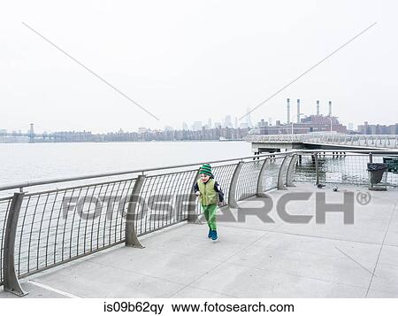 Boy running along waterfront, New York, USA View Large Photo Image Stock Photo - Boy running along waterfront, New York, USA. Fotosearch