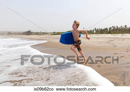 Boy running on beach, Goa, India, Asia View Large Photo Image Picture - Boy running on beach, Goa, India, Asia. Fotosearch