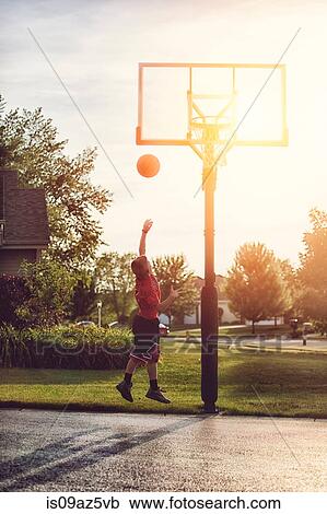 Boy shooting a basketball hook shot View Large Photo Image Stock Image - Boy shooting a basketball hook shot. Fotosearch