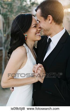 Bride and groom, face to face, holding hands, smiling View Large Photo Image Stock Photo - Bride and groom, face to face, holding hands, smiling. Fotosearch