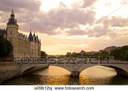 Bridge over river at sunset, Paris, France View Large Photo Image Stock Image - Bridge over river at sunset, Paris, France. Fotosearch
