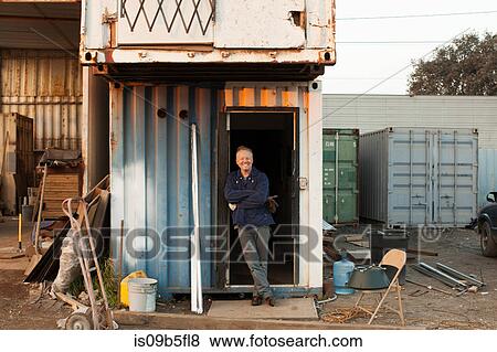 Builders leaning against doorway of corrugated shack View Large Photo Image Stock Photo - Builders leaning against doorway of corrugated shack. Fotosearch
