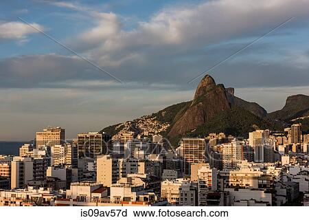 Stock Image - Buildings beneath mountains, Leblon, Rio de Janeiro, Brazil. Fotosearch