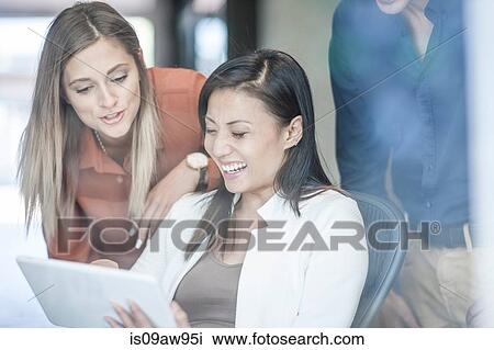 Business colleagues looking at digital tablet View Large Photo Image Stock Image - Business colleagues looking at digital tablet. Fotosearch