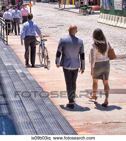 Business people walking along street, mature man pushing bike, rear view View Large Photo Image Stock Photography - Business people walking along street, mature man pushing bike, rear view. Fotosearch
