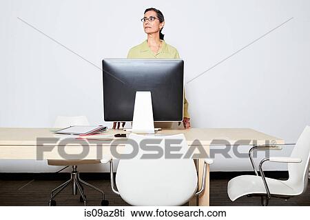 Business woman behind computer monitor looking away View Large Photo Image Stock Image - Business woman behind computer monitor looking away. Fotosearch