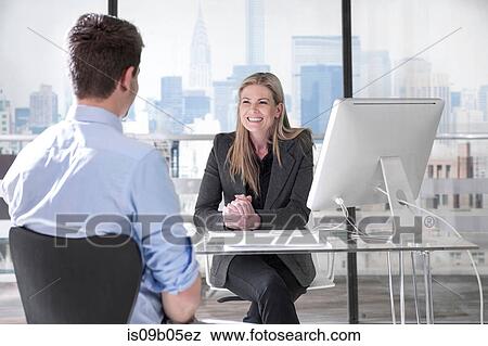 Businessman and businesswoman chatting in office View Large Photo Image Stock Photo - Businessman and businesswoman chatting in office. Fotosearch