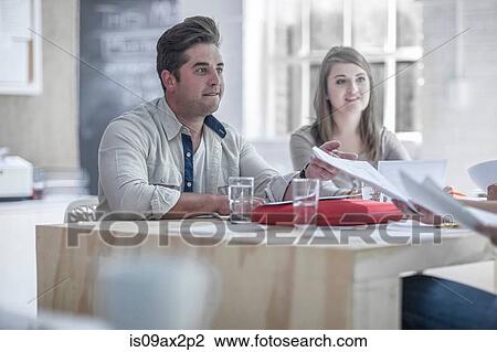 Businessman and businesswoman brainstorming in loft office View Large Photo Image Stock Image - Businessman and businesswoman brainstorming in loft office. Fotosearch