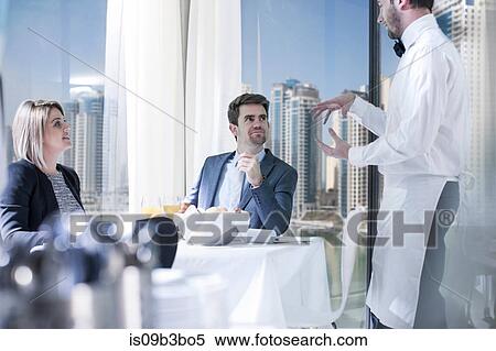 Businessman and woman at breakfast in hotel restaurant View Large Photo Image Stock Photography - Businessman and woman at breakfast in hotel restaurant. Fotosearch
