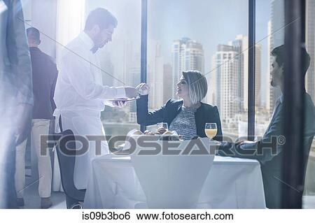 Businessman and woman having breakfast in hotel restaurant View Large Photo Image Stock Photograph - Businessman and woman having breakfast in hotel restaurant. Fotosearch
