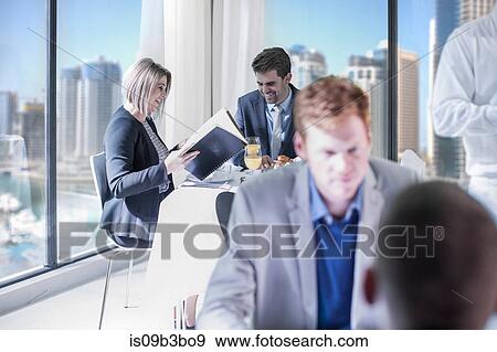 Businessman and woman reading breakfast menu in hotel restaurant View Large Photo Image Stock Photo - Businessman and woman reading breakfast menu in hotel restaurant. Fotosearch