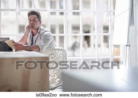 Businessman contemplating in office View Large Photo Image Picture - Businessman contemplating in office. Fotosearch