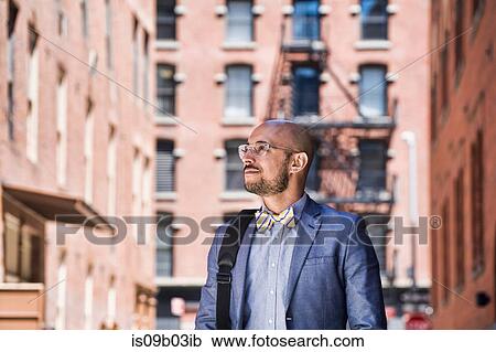Businessman outdoors, looking away View Large Photo Image Stock Image - Businessman outdoors, looking away. Fotosearch