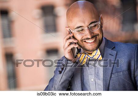 Businessman outdoors, using smartphone, smiling View Large Photo Image Stock Image - Businessman outdoors, using smartphone, smiling. Fotosearch