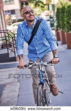 Businessman riding bike in street View Large Photo Image Stock Photograph - Businessman riding bike in street. Fotosearch
