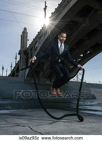 Businessman skipping, Los Angeles river, California, USA View Large Photo Image Stock Photo - Businessman skipping, Los Angeles river, California, USA. Fotosearch