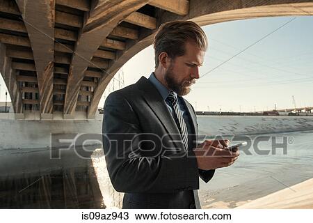 Businessman texting, Los Angeles river, California, USA View Large Photo Image Stock Image - Businessman texting, Los Angeles river, California, USA. Fotosearch