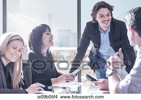 Businessmen and businesswomen meeting in office View Large Photo Image Picture - Businessmen and businesswomen meeting in office. Fotosearch