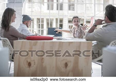 Businessmen and businesswomen brainstorming in loft office View Large Photo Image Stock Image - Businessmen and businesswomen brainstorming in loft office. Fotosearch
