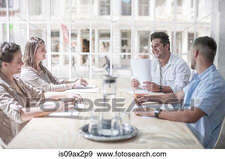Businessmen and businesswomen brainstorming in loft office View Large Photo Image Stock Photo - Businessmen and businesswomen brainstorming in loft office. Fotosearch