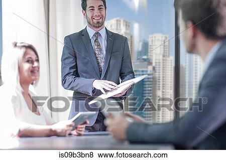Businessmen and woman meeting in conference room View Large Photo Image Stock Photo - Businessmen and woman meeting in conference room. Fotosearch