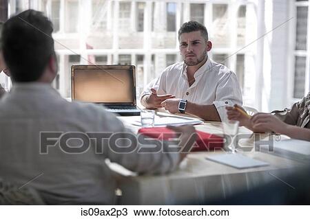 Businessmen brainstorming in loft office View Large Photo Image Stock Image - Businessmen brainstorming in loft office. Fotosearch